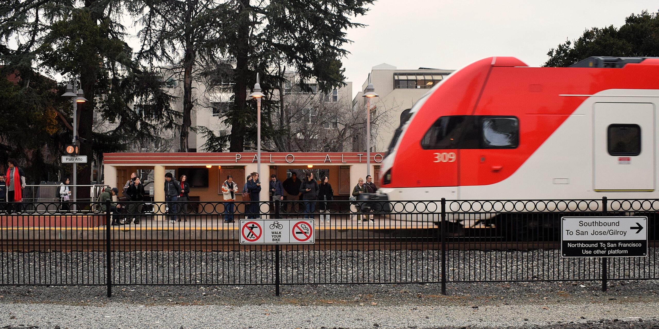 Image of a Caltrain’s new electric trains pulls into the station at Palo Alto, CA.