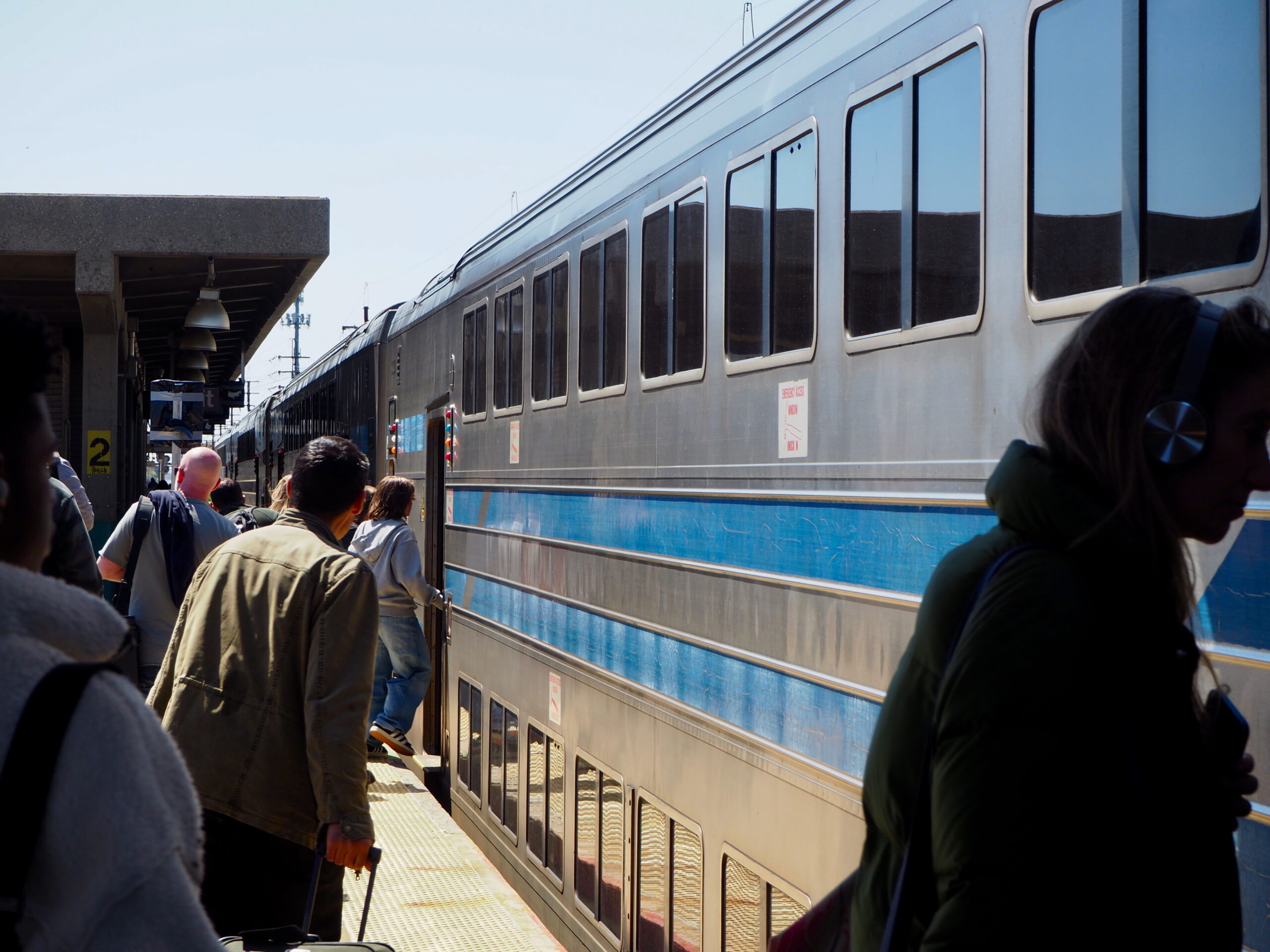 Image of LIRR riders change to a diesel train at LIRR Babylon station , the current end of the electric service area on the South Shore line.